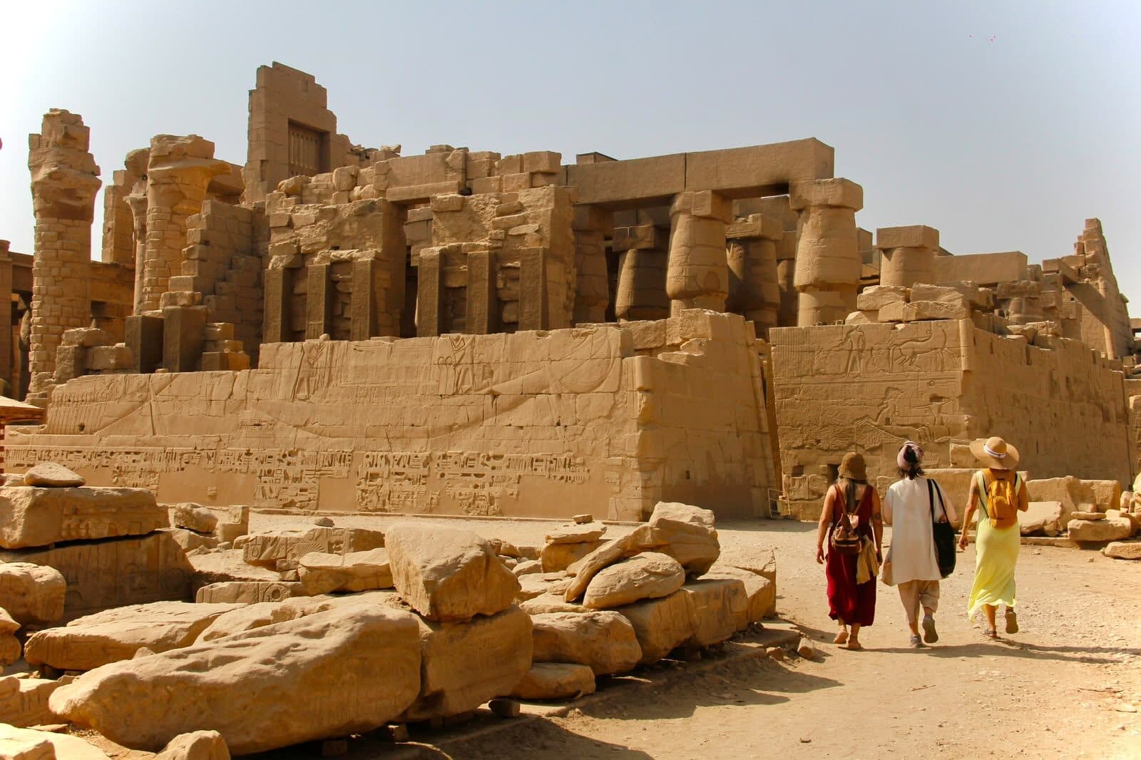 Dos viajeras caminando entre las ruinas de Karnak al mediodía